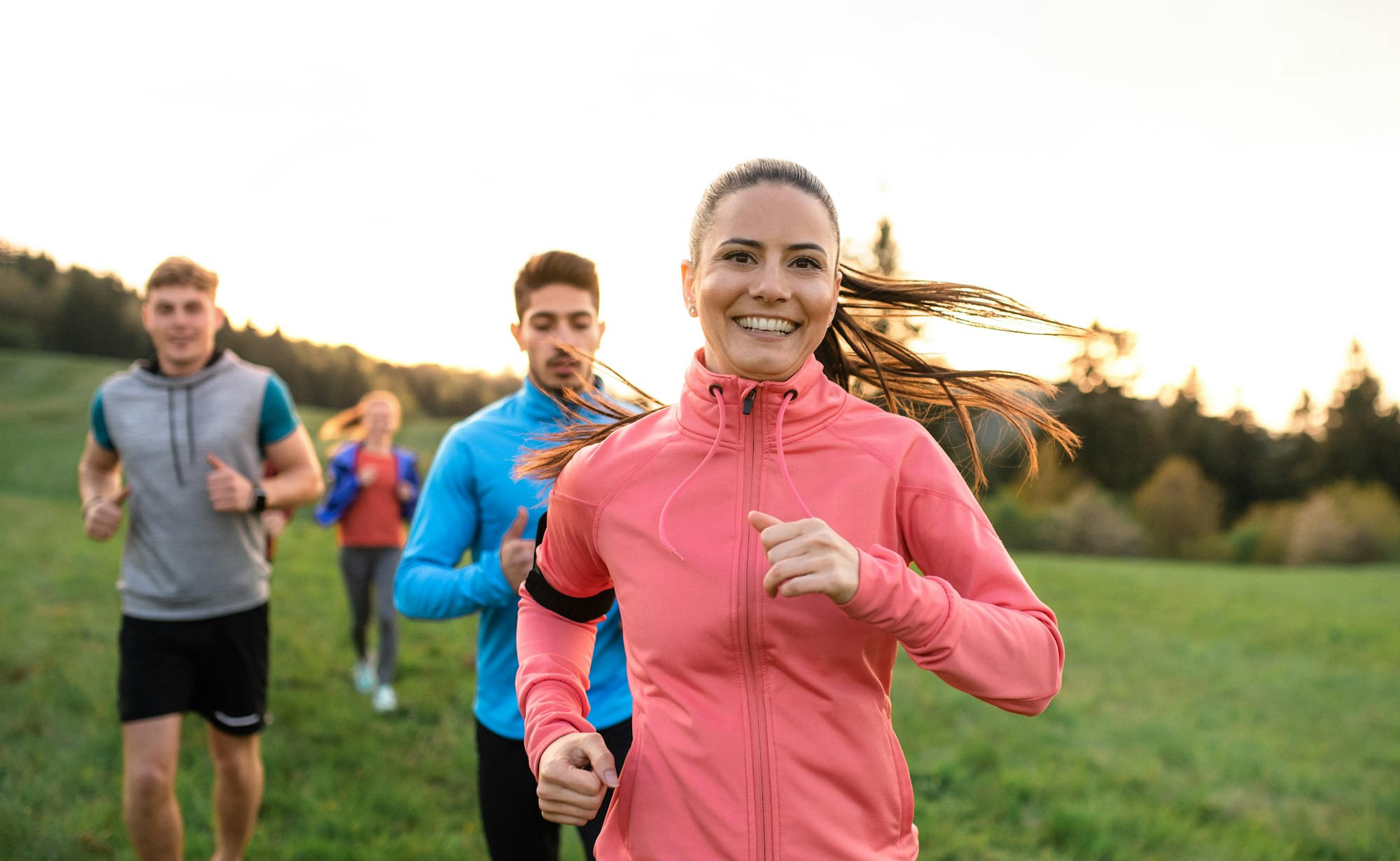 A large group of people cross country running in nature